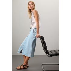 Light blue denim (100% Cotton). Skirt. Front zipper fly with button closure. 31" from shoulder to hemline. Imported. Blue Lined Midi Wrap Skirt, Blue Relaxed Fit Midi Wrap Skirt, Blue Non-stretch Mid-rise Denim Skirt, Mid-rise Denim Blue Cotton Skirt, Non-stretch Blue Cotton Denim Skirt, Simple Tank Tops, Madewell Denim, Rent The Runway, Light Blue Denim