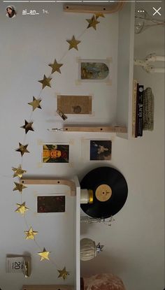 there is a record on the wall with gold stars hanging from it's sides