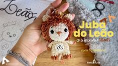 a small crocheted lion keychain being held by someone's hand