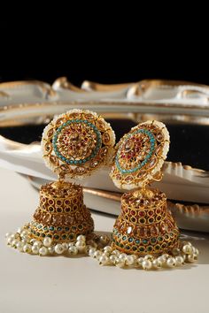 Embrace the elegance and artistry with the beautiful Samreen Jhumka Earrings. Crafted from high-quality brass and adorned with soft colors, these jhumka earrings are designed to make you stand out. Featuring multicolor navratan stones and gold plating with zircon stones, these 3-inch earrings are both chic and statement-making. These elegant jhumka earrings are not just a piece of jewelry but a statement art. With a push pin back and earring support backing, they ensure comfortable wear. Perfect