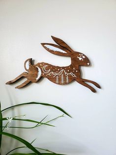 a wooden rabbit is hanging on the wall