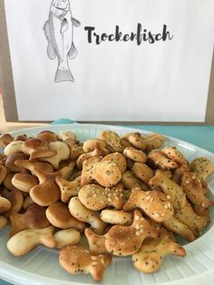 a white plate topped with lots of different types of cookies next to a sign that says stockfish