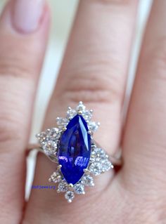 Metal: 14K White Gold Stone Types: Tanzanite And Diamonds Stone Shapes: Marquise tanzanite and round diamonds. Tanzanite Weight: Approx. 3 Carats Diamond Weight: Approx. .93 Carats Diamond Quality: Approx. SI1 G/H Weight: 6.30 Grams Size: 6 Sizable: Yes. Please state in note to seller box at checkout or message us. Original Price: $2,150.00 Appraisal & Gem Assessment: This service conducted by a GIA graduated gemologist can be provided to you free of charge. If you would like this service, p Brilliant Cut Tanzanite Gemstones, Exquisite Tanzanite Jewelry With Prong Setting, Brilliant Cut Tanzanite Gemstones For Gift, Brilliant Cut Tanzanite Gemstones As Gift, Brilliant Cut Round Tanzanite Gemstones, Wedding Brilliant Cut Tanzanite Gemstones, Sapphire Multi-stone Diamond Gemstones, Exquisite Tanzanite Diamond Ring With Center Stone, Timeless Tanzanite Jewelry With Center Stone