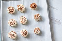 twelve cinnamon rolls on a baking sheet ready to be baked in the oven for christmas