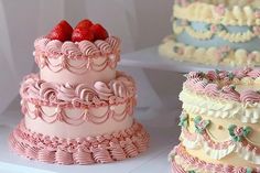 there are three different types of cakes on the table together, one is pink and white