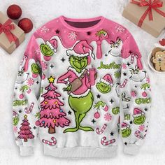 the grinch christmas sweater is on display next to presents