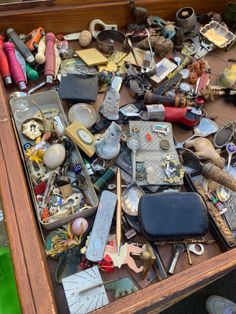 an old wooden box filled with lots of assorted items on top of a table