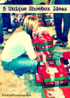 a woman kneeling down next to boxes filled with christmas presents