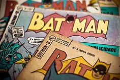 batman comic covers are stacked on top of each other in this close up photo,