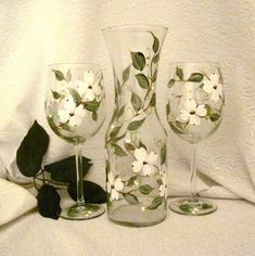 three wine glasses with flowers painted on them