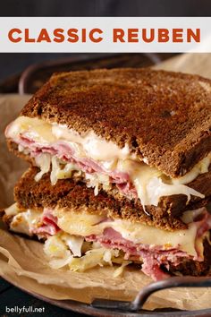 a close up of a sandwich on a plate with the words classic reuben written above it