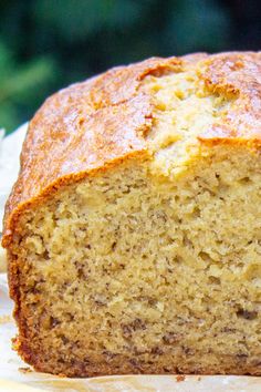 a loaf of banana bread sitting on top of wax paper