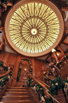 the ceiling is decorated with christmas garlands and lights, as well as wreaths