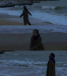 the woman is walking on the beach at night and in the distance, there are waves crashing