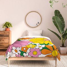 a bed in a room with plants on the floor and a round mirror above it