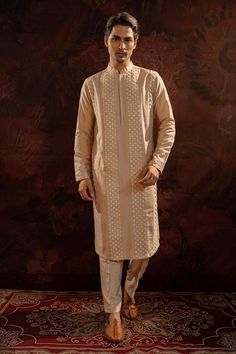 Pearl cotton silk straight kurta with pintuck pattern. Paired with straight pant.
Components: 2
Pattern: Pintuck
Neckline: Stand Collar
Sleeve Type: Full Sleeves
Fabric: Cotton Silk
Color: Beige
Other Details: 
Potli buttons
Occasion: Sangeet - Aza Fashions Designer Kurta For Diwali With Straight Pants, Beige Chanderi Kurta With Dabka Detailing, Unstitched Kurta With Straight Pants For Diwali, Festive Straight Kurta With Dabka Detailing, Festive Kurta With Dabka And Straight Pants, Festive Dabka Kurta With Straight Pants, Chikankari Embroidered Straight Kurta For Festivals, Beige Straight Naqshi Kurta, Beige Naqshi Straight Kurta