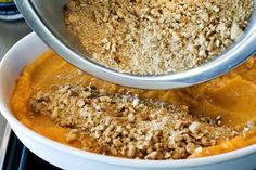 two bowls filled with food on top of a stove next to each other and one bowl containing oatmeal