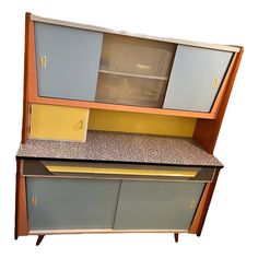 an old fashioned kitchen cabinet with granite counter top and doors on both sides, is shown against a white background