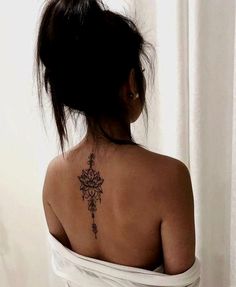 a woman with a flower tattoo on her back