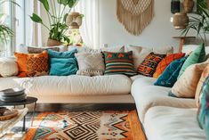 a living room filled with lots of furniture and pillows on top of a white couch