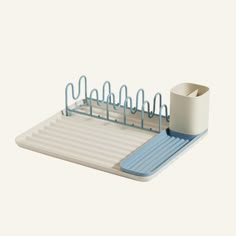 a blue and white dish rack with two cups on it