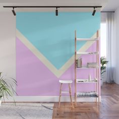 a living room with pink, blue and yellow wallpaper on the walls next to a ladder