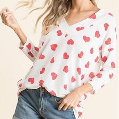 White & Red Heart V-Neck Three-Quarter Sleeve Top Color: Red & White Material: 95% Polyester 5% Spandex Fit: True To Size Spring Heart Print V-neck Top, Red Tops With Heart Graphic For Spring, Red Heart Graphic Top For Spring, Heart Print V-neck Top For Spring, Spring V-neck Top With Heart Print, Casual V-neck Top With Heart Print, V-neck Top With Heart Graphic For Summer, V-neck Tops With Heart Graphic For Summer, Spring V-neck Top With Heart Graphic