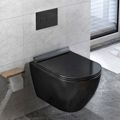 a black toilet sitting next to a wall mounted urinal in a bathroom under a window