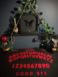 a black table topped with red letters and plants