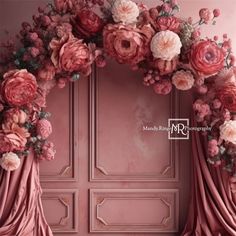 a pink door with flowers on it and drapes in front of the doors are closed