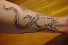 a person's arm with an octopus tattoo on it