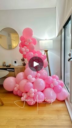 a bunch of balloons that are on the ground in front of a door and window