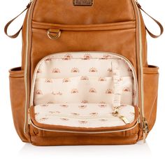 a brown backpack with the front pocket open and it's zippered out to reveal an inner compartment