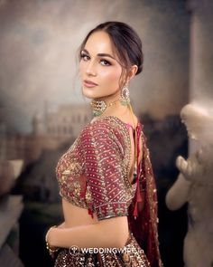 a beautiful woman in a red and gold dress