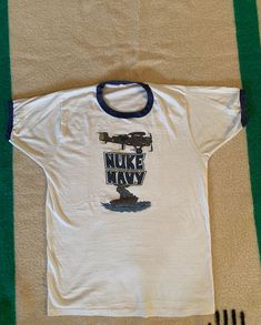 Nice vintage ringer t shirt, great graphics. Single stitch, tube knit (no side seams). Tags are faded but it is made in USA. One small hole in the back at the base of the collar. Measurements: 19 1/2 inches from pit to pit measured lying flat, 15 inches across the shoulders, the overall length is 26 1/2 inches. Looks like a cotton poly blend. Us Navy Sweatshirt, Navy Crewneck, Fringe Leather Jacket, Vintage Wrangler, Cool Jackets, Mens T Shirts, Mens Graphic Tee, Vintage Denim, Vintage Tshirts