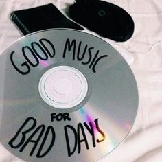 there is a cd with the words good music for bad days on it next to a pair of black shoes