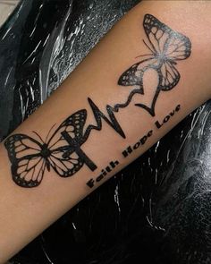 a woman's arm with butterflies on it and the words faith hope love written in black ink