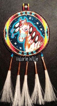 four small beaded brushes with horses in the center and fringes on each side