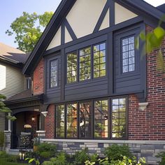 a large house with many windows and landscaping