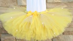 A stunning, glittery yellow and gold tutu - perfect for Belle All tutus are made with high quality tulle and a 1" non-roll waist band.  I make all my tutus very full and fluffy.  I put as much tulle as I can possibly fit. Each tutu has a matching bow attached. When measuring your child's waist, order the size that is 2 inches smaller than her actual waist since the band is made of elastic. Tutu Size Chart 0-6 mo         14" waist    6"length 6-12 mo       15"waist     6"length 12-24 mo     16"wa Tutu Size Chart, Yellow Tutu, Gold Tutu, Girls Clothing Sets, Clothing Sets, Girls Clothing, Waist Band, Mother’s Day, Outfit Sets