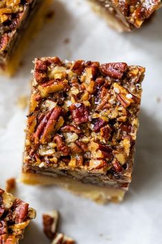 three pieces of pecan bar sitting on top of a white countertop next to each other