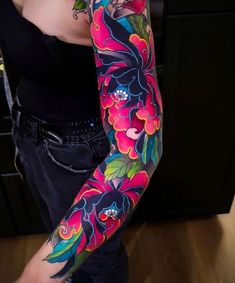 a woman with colorful tattoos on her arm