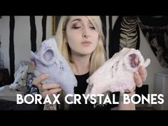 a woman is holding two crystal bones in her hands and the words borax crystal bones