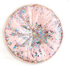 a pink plate with colorful sprinkles on it