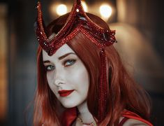 a woman with red hair wearing a tiara