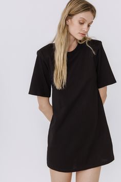 This Shoulder Pad T-Shirt Dress is a wardrobe must-have! Featuring a stylish round neckline, short sleeves, and a boxy silhouette, it's the perfect addition to any outfit. Our unique shoulder pad insert adds structure and a touch of sass, making this dress a standout. With its comfortable fit and comfortability, you'll look amazing no matter what the occasion. Show off your fashion-forward style with this shoulder-pad t-shirt dress! Shoulder pad inserted Round neckline Short sleeves Boxy silhoue Oversized Short Sleeve T-shirt Dress, Black Oversized Crew Neck T-shirt Dress, Oversized Black Crew Neck T-shirt Dress, Black Relaxed Fit T-shirt Dress With Short Sleeves, Black Relaxed Fit T-shirt Dress With Crew Neck, Black Crew Neck T-shirt Dress For Spring, Jumpsuit Fall, Blazer And Shorts, Tweed Dress