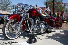 a red motorcycle parked next to a playground