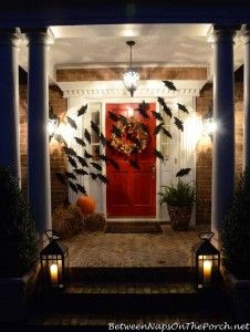 the front door is decorated with bats and pumpkins