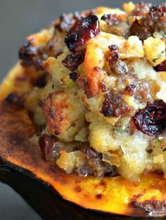 a close up of food on top of a wooden spoon with other items in the background