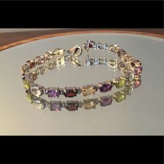 Beautiful Tennis Bracelet Made From Multiple Precious Gemstones In Stainless Steel. 7.25 In, 9.85 Ctw. New. Amethyst Garnet Sky Blue Topaz Peridot Citrine Pink Amethyst Multicolor Faceted Jewelry For Formal Occasions, Elegant Multicolor Crystal Bracelet With Jewels, Formal Multicolor Amethyst Jewelry, Elegant Multicolor Crystal Bracelet For Formal Occasions, Elegant Multicolor Crystal Bracelet For Formal Events, Elegant Multicolor Gemstone Crystal Bracelet, Elegant Multicolor Crystal Gemstone Bracelet, Multicolor Amethyst Bracelet Jewelry, Multicolor Amethyst Bracelet